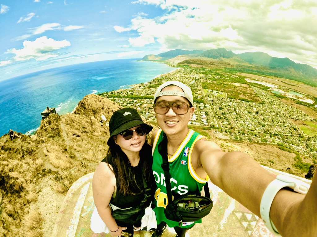 Peter and Lisa on a hike above the coastline in Hawaii, celebrating becoming YouTube Partners
