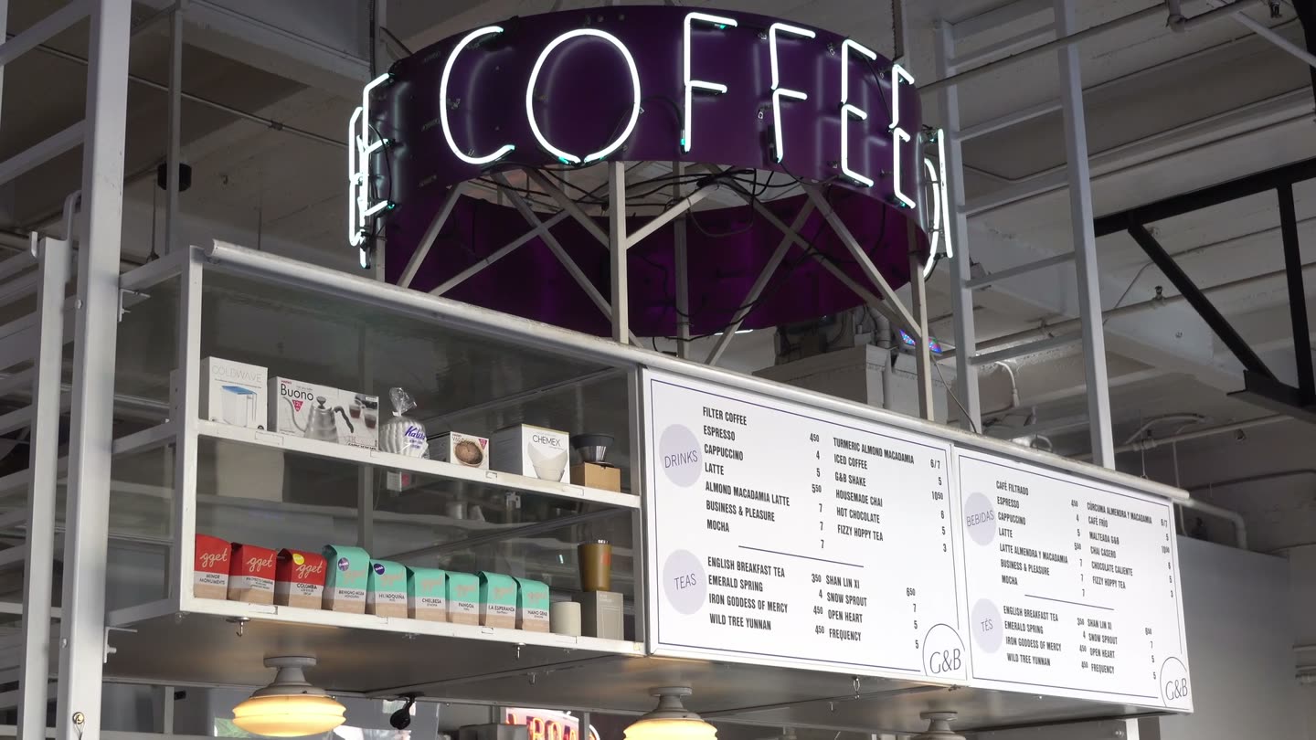 The coffee bar at Grand Central Market with its round Coffee sign and menu board