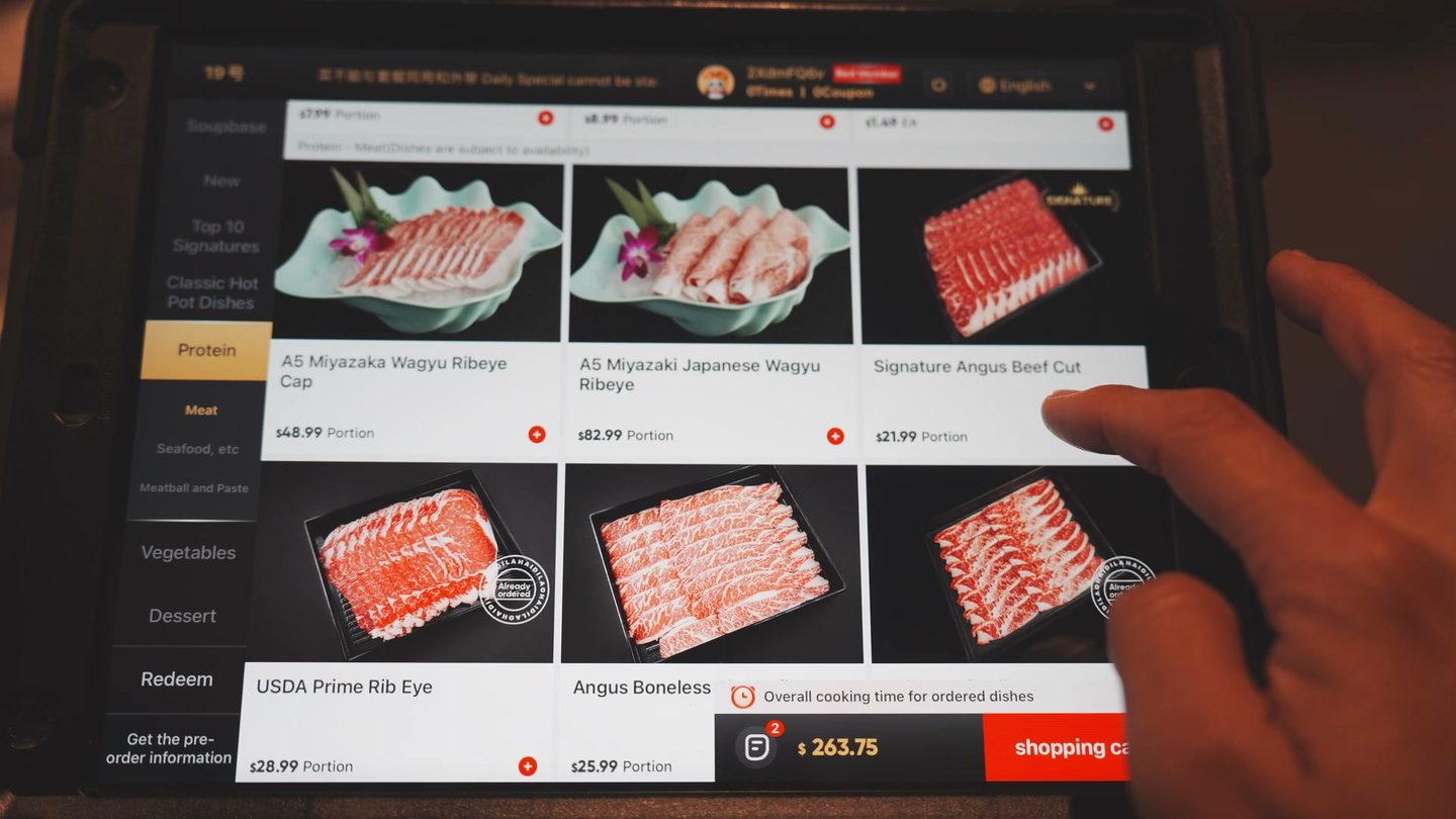 Haidilao table iPad menu showing A5 Miyazaki wagyu, Signature Angus, USDA Prime Rib Eye, and Angus Boneless with prices