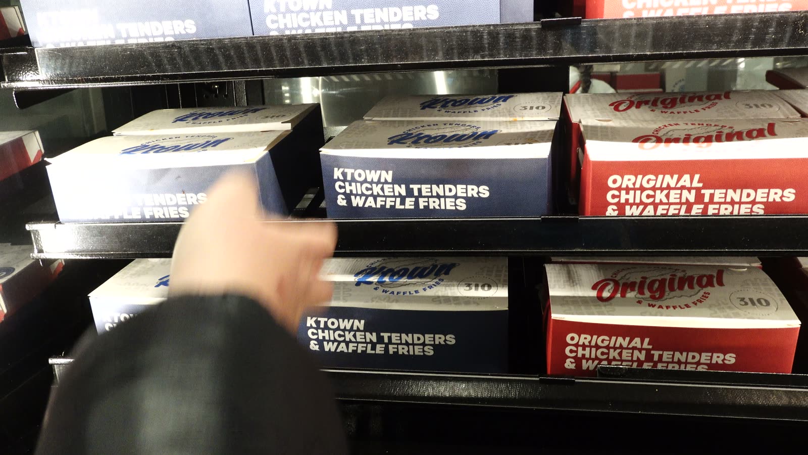 Grab-and-go market shelves with Original and Ktown chicken tenders and waffle fries boxes at Intuit Dome