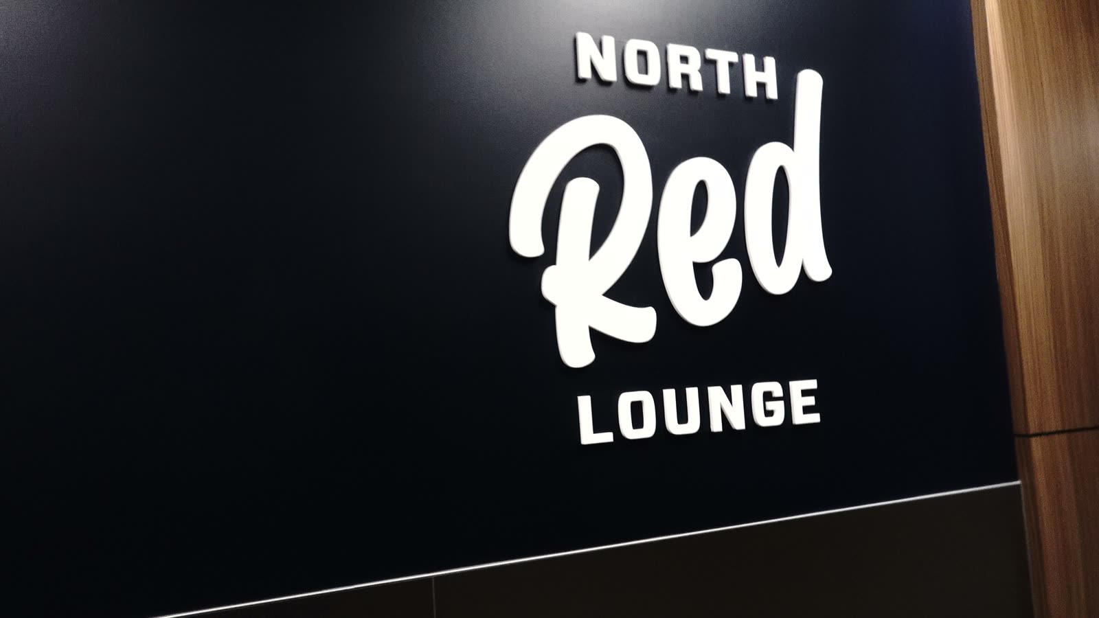 North Red Lounge sign at the floor-level all-you-can-eat lounge at Intuit Dome