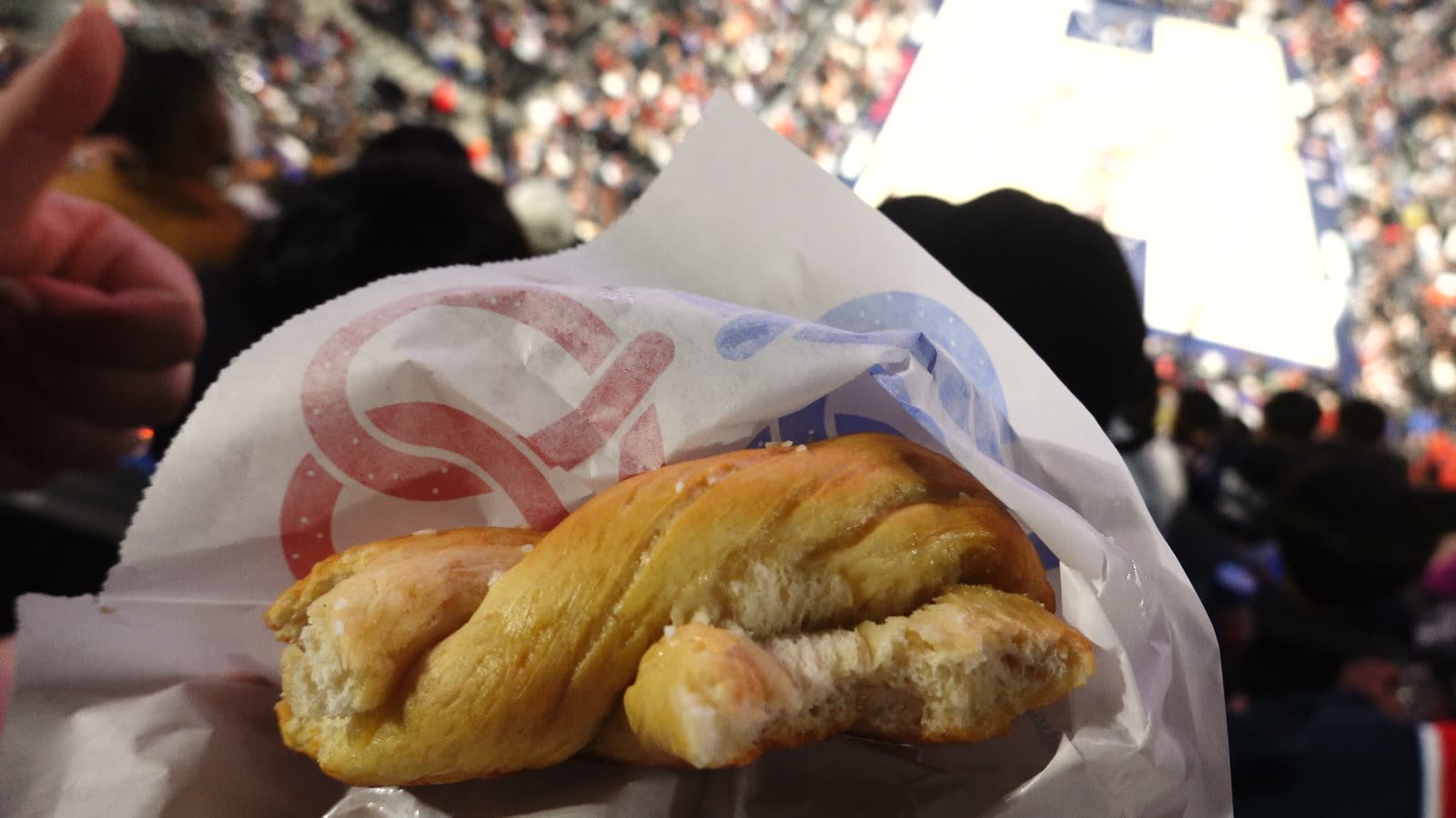 Buttery soft pretzel in a paper sleeve at a Clippers game at Intuit Dome