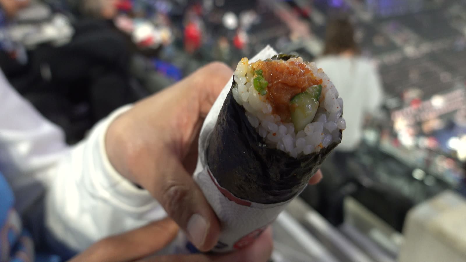 Spicy tuna sushi hand roll unwrapped at a Clippers game at Intuit Dome