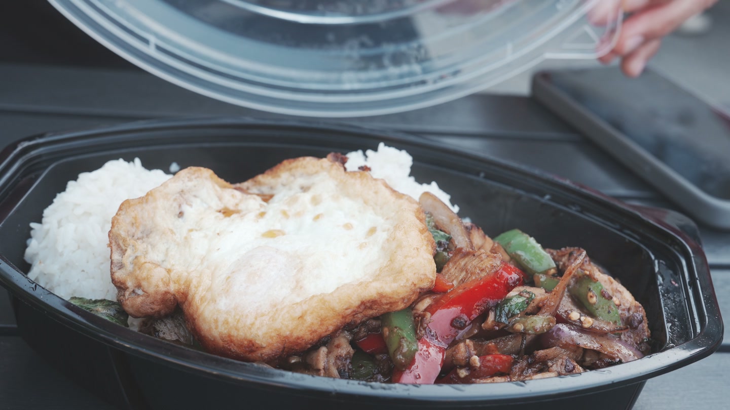 Chicken kra-pow with rice, peppers, onions, and a fried egg.