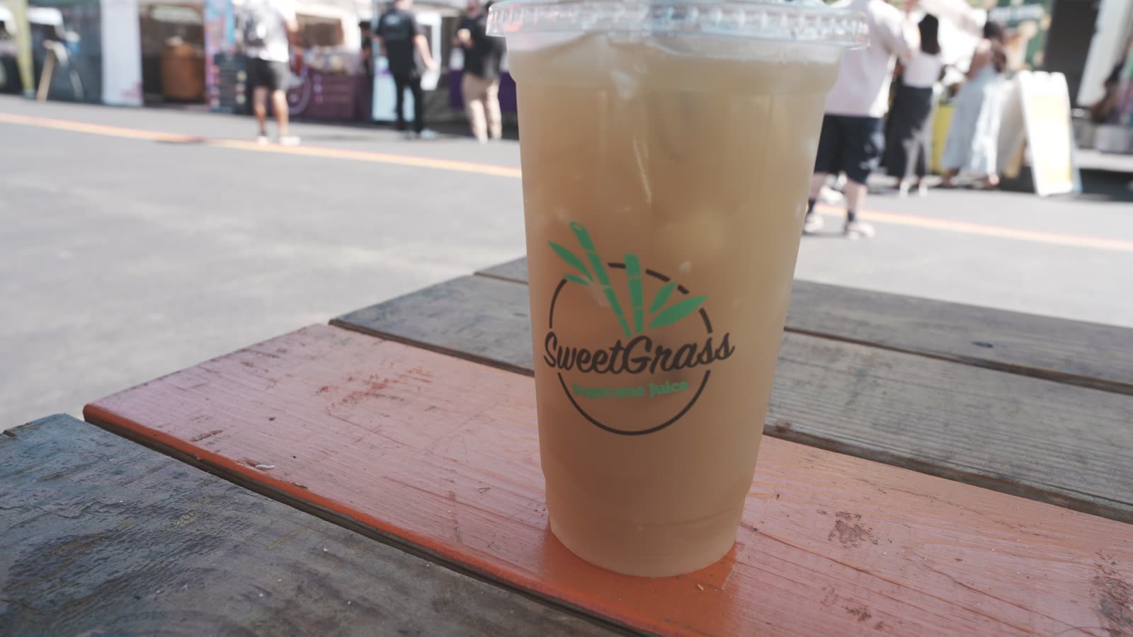 Sweet Grass Lychee Cane sugarcane juice in a branded cup