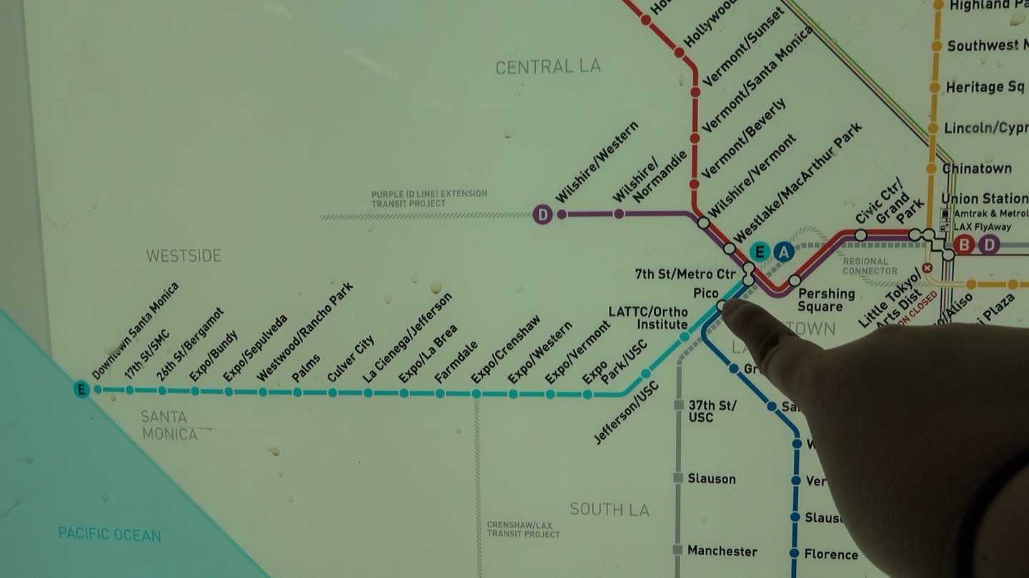 Pointing at 7th St/Metro Center on a Metro rail map, where the subway lines meet the line to Santa Monica