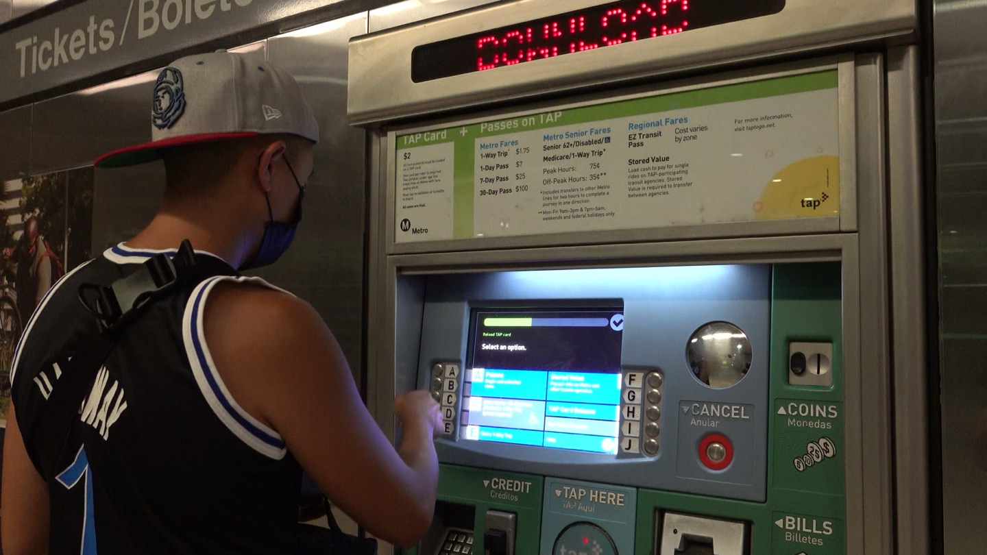Peter buying a fare at a green TAP vending machine in Union Station
