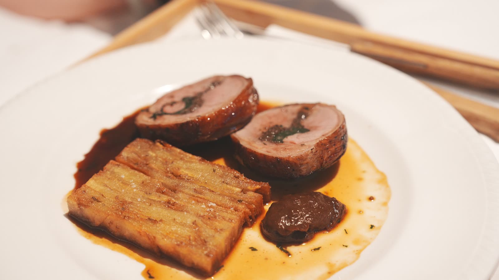 Room service plate of New Zealand lamb with layered potatoes from Bistro Saine at Hotel Indigo Auckland