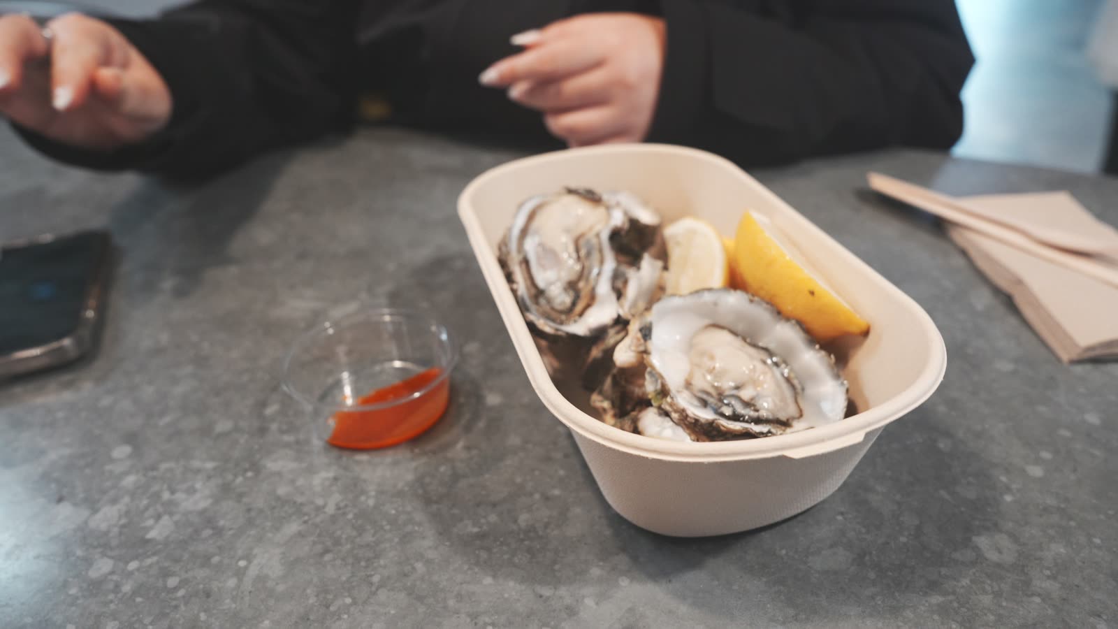Freshly shucked oysters with lemon and Tabasco at the Auckland Fish Market