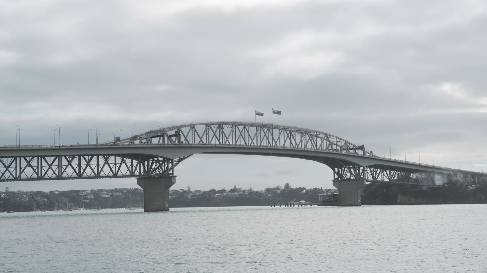 The Auckland Harbour Bridge over the Waitematā Harbour on a cloudy day
