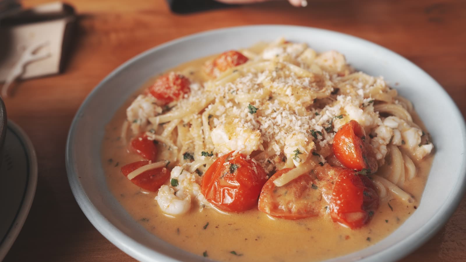 Linguini with scampi, cherry tomatoes, and breadcrumbs in a creamy tomato sauce at The Shucker Brothers