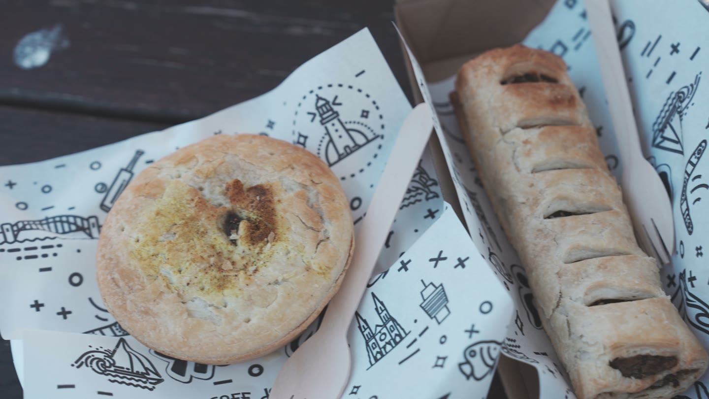 Our beef curry pie and sausage roll from Harry’s Café de Wheels.