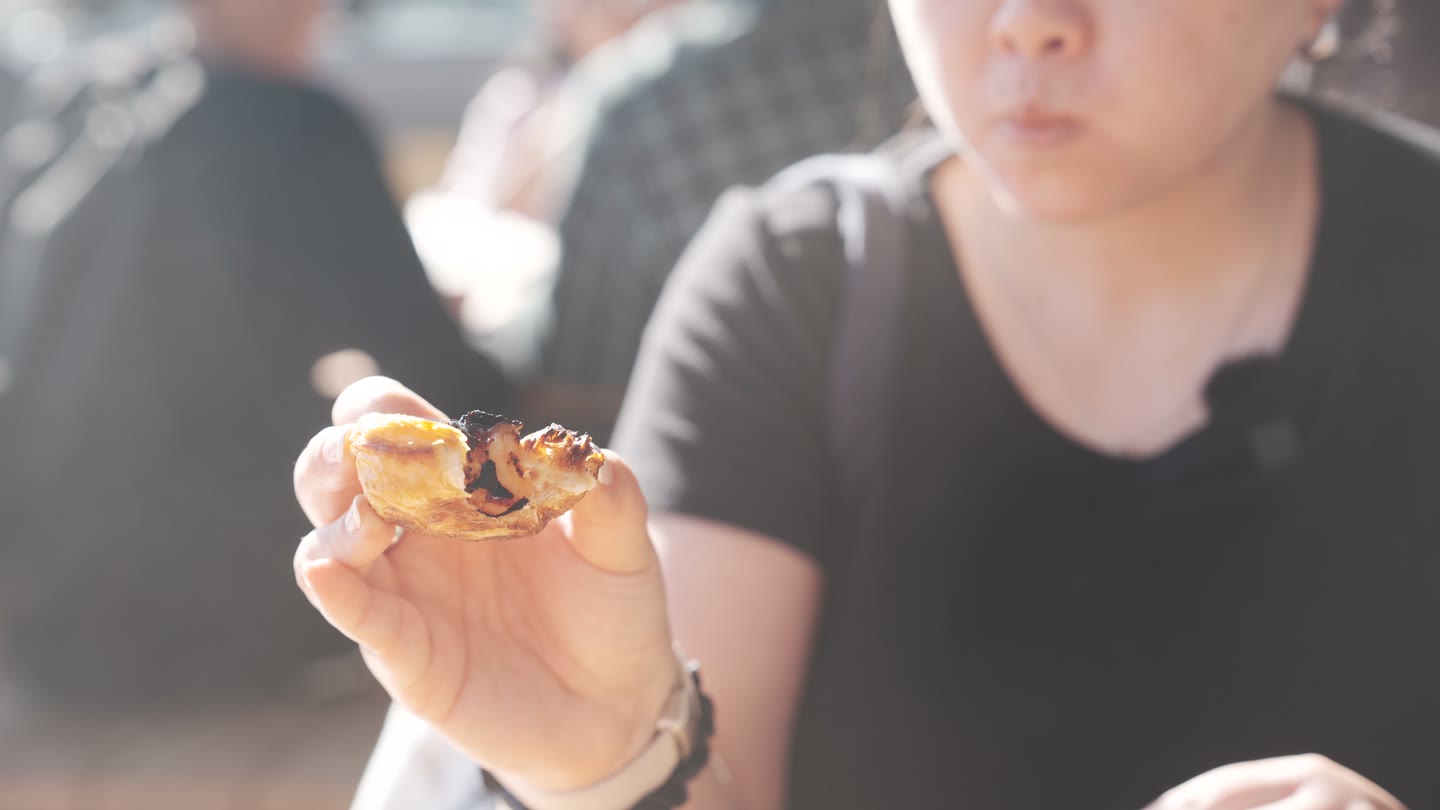 Lisa trying the Portuguese egg tart from Stitch Coffee at Sydney Fish Market.
