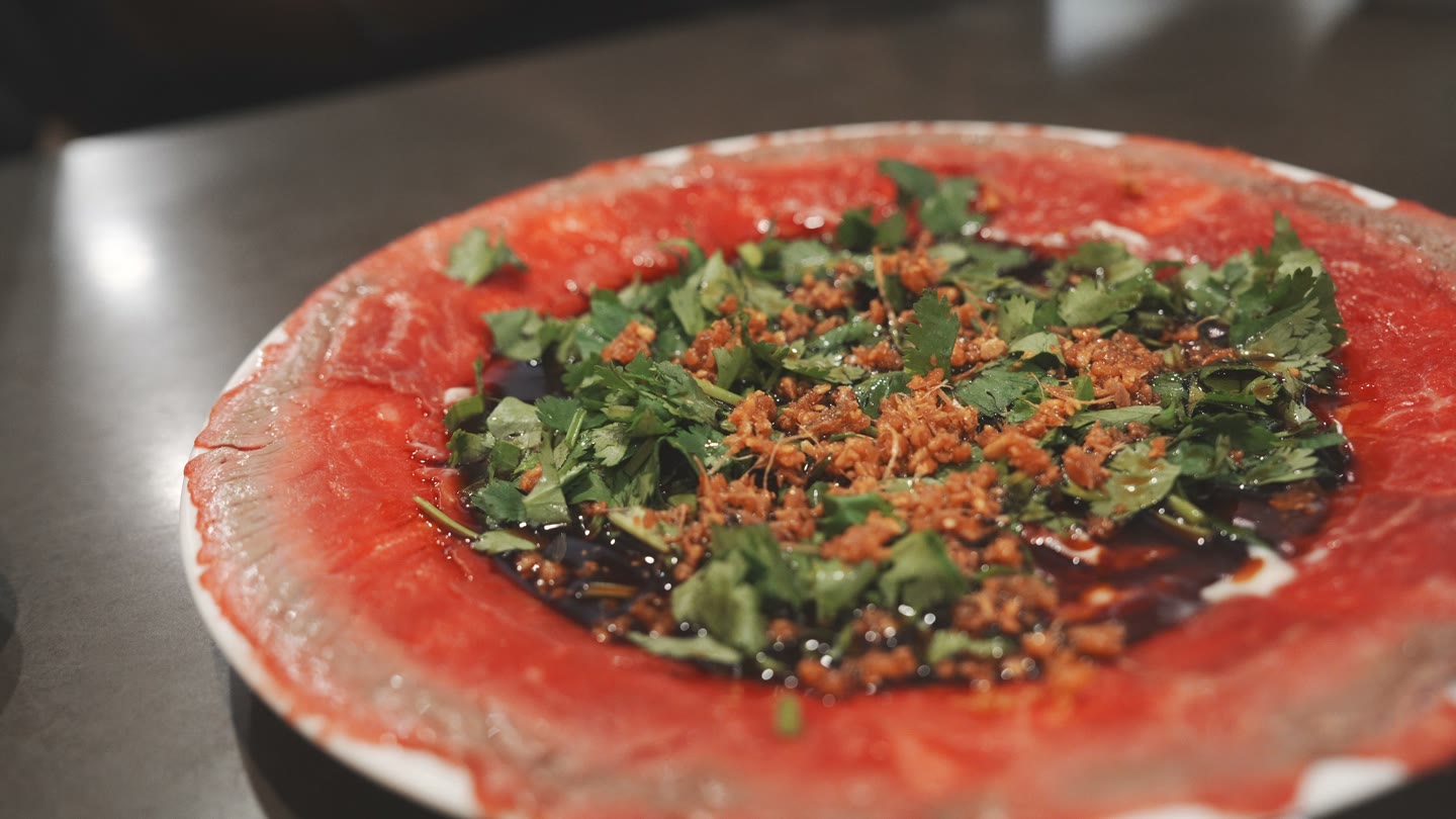 The thinly sliced butter beef at Phnom Penh, with herbs and garlic.